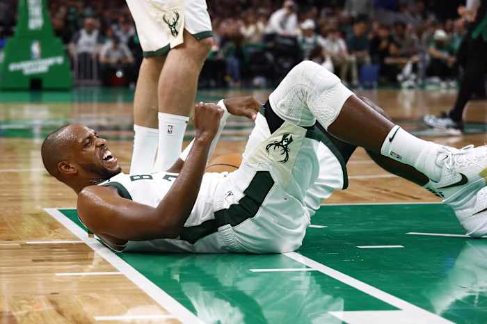Milwaukee Bucks forward Khris Middleton (22) grimaces after being knocked down during the second half against the Boston Celtics